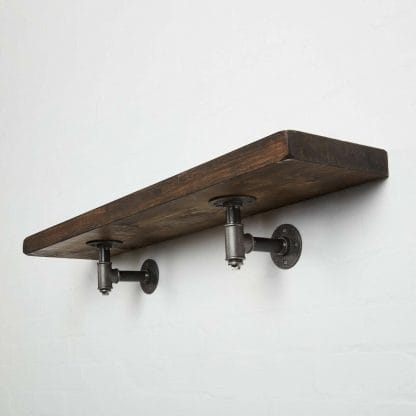 reclaimed wooden shelf with industrial steel pipe brackets