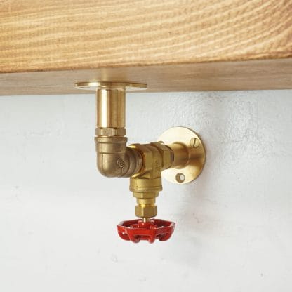 brass industrial pipe shelf bracket with red tap valve detailing