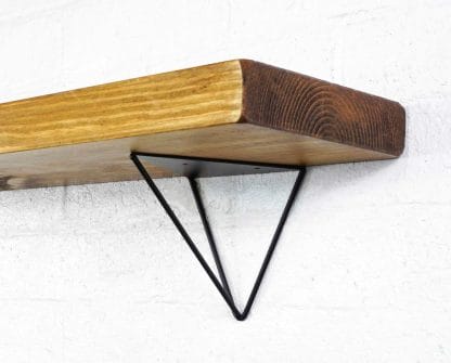 Black steel hairpin shelf brackets with reclaimed wooden shelf