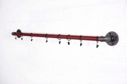 red industrial pipe curtain pole with raw steel fixings and curtain hooks