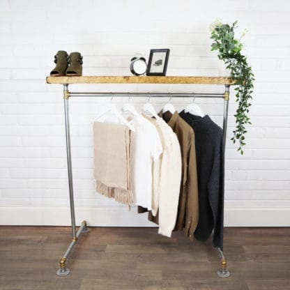 industrial steel industrial pipe clothes rail with brass elbows and reclaimed wood shelf
