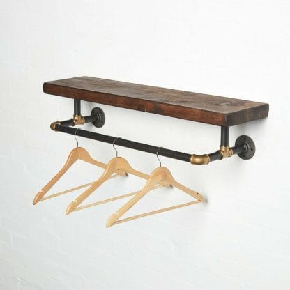 raw steel industrial pipe shelf with brass elbows, hanging rail and dark wood reclaimed shelf