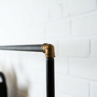 Raw-Steel-And-Brass-Clothes-Rail-with-Reclaimed-Timber-Shelving-4